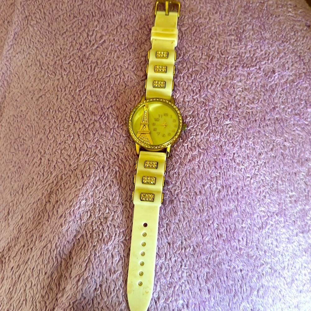 White and gold watch. Eiffel Tower with rhinestones.